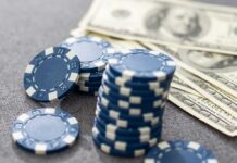 Stack of blue poker chips next to cash bills