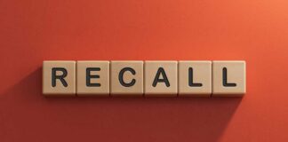 Wooden letter tiles spelling recall on an orange background