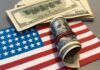 Banks Can Now Ask: Visa or Mortgage? A roll of hundred dollar bills placed on an American flag