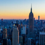 Spire Stunt Ends In Felonies Empire State Building at sunset over Manhattan skyline